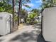An iron gate between stucco walls gives access to the long drive leading to this secluded property at 37918 N County Road 44A, Eustis, FL 32736