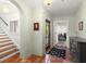 Welcoming entryway featuring a staircase, tiled floors, and a decorative chandelier at 37918 N County Road 44A, Eustis, FL 32736
