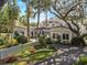 Elegant estate home with a tile roof, mature trees, and lush landscaping at 37918 N County Road 44A, Eustis, FL 32736