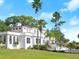 Expansive estate boasts lush landscaping, a neutral exterior, and an open lawn at 37918 N County Road 44A, Eustis, FL 32736