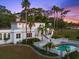 Back of home featuring a beautiful pool, landscaping, and sprawling white facade at 37918 N County Road 44A, Eustis, FL 32736