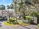 Beautiful Spanish style white home boasts lush landscaping, circle driveway, and a walled courtyard at 37918 N County Road 44A, Eustis, FL 32736