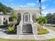 Charming home exterior featuring an arched entryway and symmetrical landscaping at 37918 N County Road 44A, Eustis, FL 32736