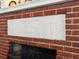 Close-up of a red brick fireplace with a white mantel featuring detailed architectural designs at 37918 N County Road 44A, Eustis, FL 32736
