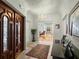 Elegant foyer featuring a grand wood door, tile flooring, and a chandelier at 37918 N County Road 44A, Eustis, FL 32736