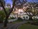 A large driveway curves to the entrance of this stately home with well-manicured, mature landscaping at 37918 N County Road 44A, Eustis, FL 32736