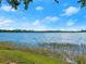 Tranquil lake view with lush greenery along the shoreline under a clear blue sky at 37918 N County Road 44A, Eustis, FL 32736