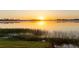 Beautiful lake view home with sun rising on the horizon creating a peaceful environment at 37918 N County Road 44A, Eustis, FL 32736