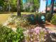 Secluded outdoor seating area with blooming flowers and bushes overlooking the grounds of this stunning property at 37918 N County Road 44A, Eustis, FL 32736