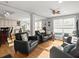 Cozy living room featuring hardwood floors and a seating area with a kitchen and dining room in the background at 37918 N County Road 44A, Eustis, FL 32736