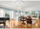 Bright living room with parquet floors, elegant chandeliers, and large windows providing natural light at 37918 N County Road 44A, Eustis, FL 32736