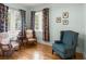 Inviting sitting room with three chairs, hardwood floors, and a large window view at 37918 N County Road 44A, Eustis, FL 32736