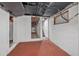 Basement area featuring steps leading to another level and red flooring at 401 N Oleander Ave, Daytona Beach, FL 32118