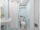 Basement bathroom area featuring a toilet, sink, and white shower curtain at 401 N Oleander Ave, Daytona Beach, FL 32118