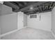Basement area featuring light gray walls, white floor tiles, and a small window at 401 N Oleander Ave, Daytona Beach, FL 32118