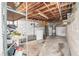 Unfinished basement utility area with a washer, dryer, and hot water tank at 401 N Oleander Ave, Daytona Beach, FL 32118