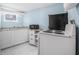 Basement area featuring a kitchen with white cabinets, stove, and a microwave at 401 N Oleander Ave, Daytona Beach, FL 32118