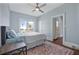 Bright bedroom with hardwood floors, ceiling fan, area rug and sunny windows at 401 N Oleander Ave, Daytona Beach, FL 32118