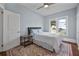 Inviting bedroom featuring a plush bed, hardwood floors with area rug and a ceiling fan at 401 N Oleander Ave, Daytona Beach, FL 32118