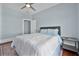Spacious bedroom with natural light, hardwood floors, and a modern ceiling fan at 401 N Oleander Ave, Daytona Beach, FL 32118