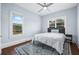 Cozy bedroom with large windows for natural light, area rug and ceiling fan at 401 N Oleander Ave, Daytona Beach, FL 32118