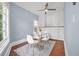 Bright dining area featuring hardwood floors, modern table and chairs, with a ceiling fan and beautiful cabinet storage at 401 N Oleander Ave, Daytona Beach, FL 32118