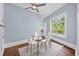 Dining room featuring a glass table with four white chairs and a large window at 401 N Oleander Ave, Daytona Beach, FL 32118