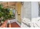 Entrance with a yellow front door, brick steps, and white railing at 401 N Oleander Ave, Daytona Beach, FL 32118
