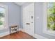 Entryway featuring hardwood floors, a white front door, and plenty of natural light at 401 N Oleander Ave, Daytona Beach, FL 32118