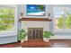 Close up of living room fireplace with plants and art on mantle at 401 N Oleander Ave, Daytona Beach, FL 32118
