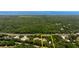 Aerial shot showcasing the property's location near the water with surrounding greenery at 486 S Us Highway 1, Oak Hill, FL 32759