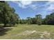Expansive backyard with lush greenery and a clear blue sky at 486 S Us Highway 1, Oak Hill, FL 32759
