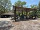 View of the barn with equipment like a mower and golf cart at 486 S Us Highway 1, Oak Hill, FL 32759