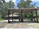 Rustic barn structure with covered shelter, providing ample space for various outdoor activities at 486 S Us Highway 1, Oak Hill, FL 32759