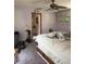 Bedroom showing renovation with lavender walls, ceiling fan and storage drawers under the bed at 486 S Us Highway 1, Oak Hill, FL 32759