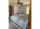Cozy bedroom with a bed, ceiling fan, and a view into the en suite bathroom at 486 S Us Highway 1, Oak Hill, FL 32759