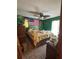Bedroom with a ceiling fan, large bed, and eclectic decor at 486 S Us Highway 1, Oak Hill, FL 32759