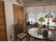 Charming dining area with a window displaying a collection of lamps and a vintage-style table at 486 S Us Highway 1, Oak Hill, FL 32759