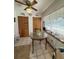Bright dining area with a round table, floral centerpiece, and natural light from a window with lace curtains at 486 S Us Highway 1, Oak Hill, FL 32759