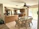 Bright dining area next to kitchen boasts tile floors, a ceiling fan, and sliding glass doors at 486 S Us Highway 1, Oak Hill, FL 32759