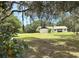 Charming house with mature trees and expansive lawn at 486 S Us Highway 1, Oak Hill, FL 32759