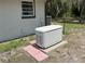 Image shows the Generac generator on a concrete pad with access steps and the home in the background at 486 S Us Highway 1, Oak Hill, FL 32759