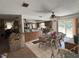 Open-concept kitchen and dining area with ample counter space, tile floors, and access to the backyard at 486 S Us Highway 1, Oak Hill, FL 32759