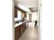 Galley kitchen features wood cabinets, tile flooring, and a bright, functional layout at 486 S Us Highway 1, Oak Hill, FL 32759