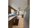 Kitchen with dark wood cabinets, tile flooring, and stainless steel appliances leading to dining area at 486 S Us Highway 1, Oak Hill, FL 32759