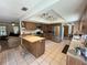 Spacious kitchen with stainless steel appliances, tile flooring, and island with seating at 486 S Us Highway 1, Oak Hill, FL 32759