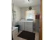 Functional laundry room with a washer, dryer, and water heater at 486 S Us Highway 1, Oak Hill, FL 32759