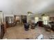 Spacious living room featuring a brick fireplace, ceiling fan, and comfortable seating area at 486 S Us Highway 1, Oak Hill, FL 32759