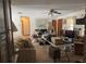 Spacious living room with a ceiling fan, a sailboat picture, comfortable seating, and ample natural light at 486 S Us Highway 1, Oak Hill, FL 32759