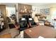 Cozy living room with a brick fireplace, comfortable seating, and ample natural light at 486 S Us Highway 1, Oak Hill, FL 32759